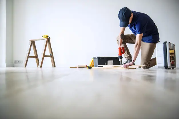 mezczyzna kladzie plytki